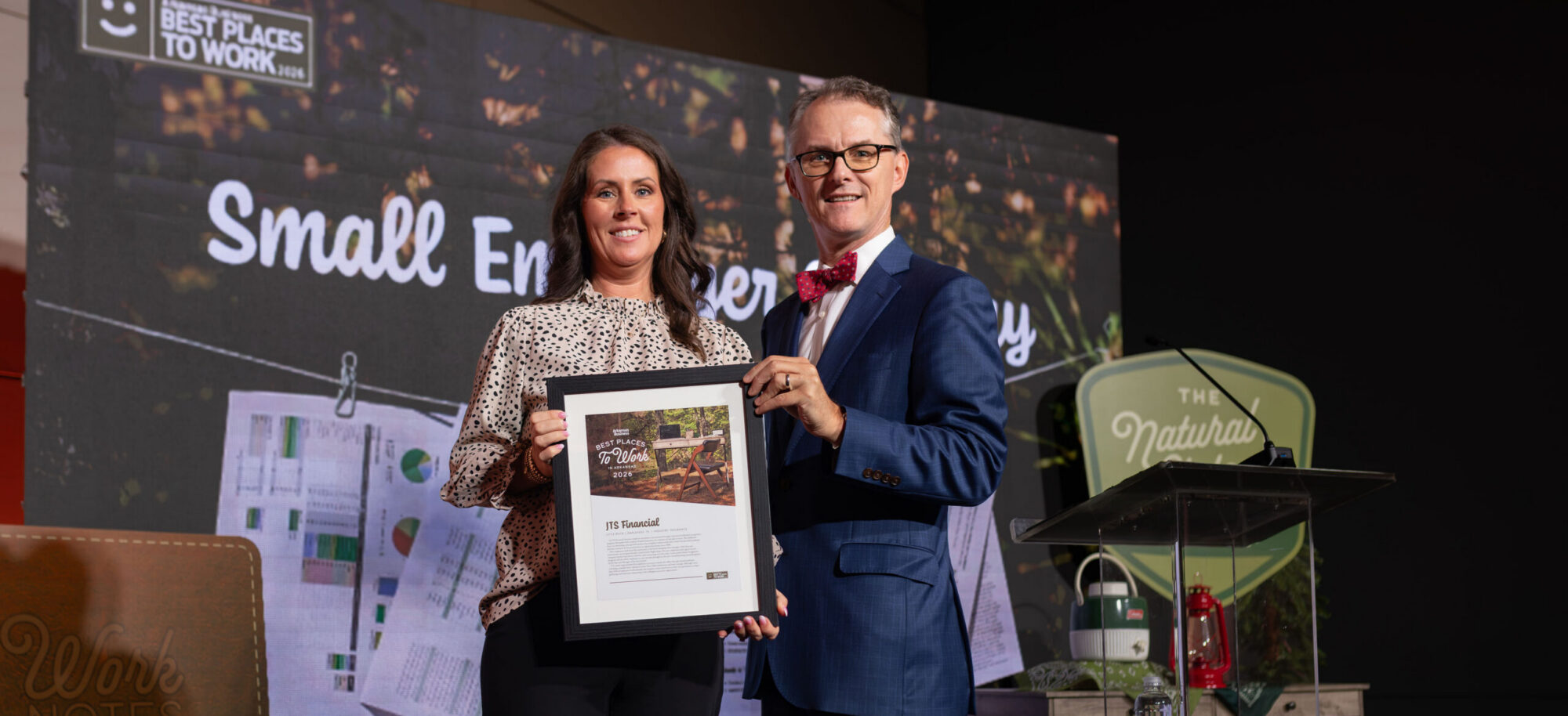 JTS receives award on stage.