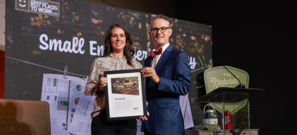 JTS receives award on stage.